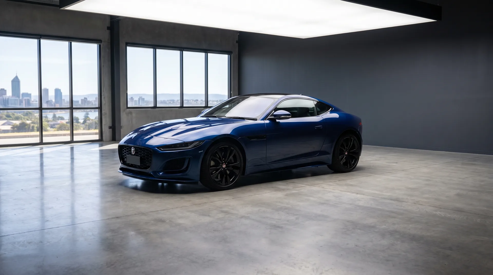 Professional car photography of a glossy blue sports coupe in a Perth studio with clean reflections