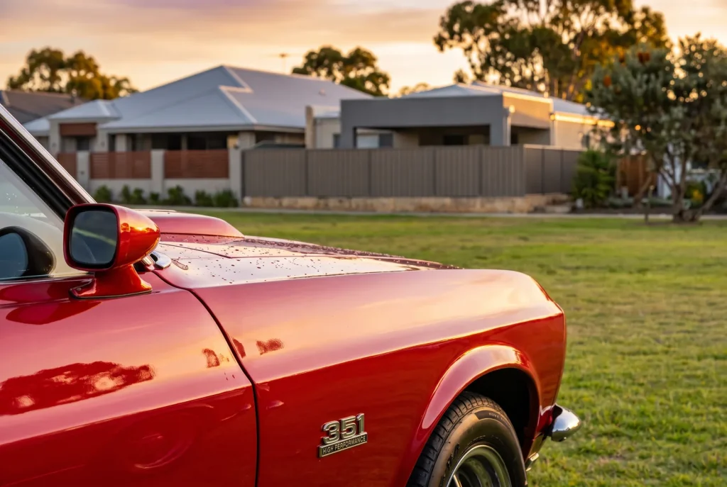 Car show event photography detail of glossy red muscle car paint and chrome in Perth